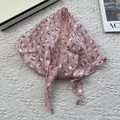 Detail of light pink floral cotton linen kerchief on a textured knit background - Pink