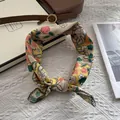 Detailed shot of yellow floral scarf with green lace trim on white table cloth - Square Style / Yellow