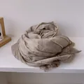 Detailed view of beige pleated cotton scarf featuring elegant lace embroidery edges - Khaki