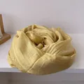 Close-up of soft pale yellow cotton linen scarf featuring elegant lace edge detailing - Yellow