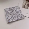 Detail of folded linen cotton bandana featuring vintage floral cashew branch patterns - Malt Beige