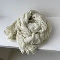 Detail of light beige cotton linen scarf featuring delicate lace edges and textured fabric - Off White