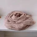 Macro detail of dusty rose linen scarf featuring pleated texture and lace edge trim - Pink