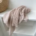 Close-up of light brown cotton linen scarf with elegant floral lace embroidery edge - Nude Pink