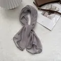Detailed view of lightweight grey-purple chiffon scarf with fine black stitched edges - 105*47cm / Gray