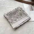 Detail of paisley cotton bandana showing high-quality stitching and bohemian pattern - Apricot Paisley