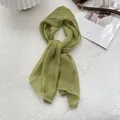 Close-up of light green chiffon scarf with elegant white wavy edges on soft white texture - 105*47cm / Matcha Green