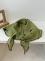 Macro detail of light green cotton linen triangle scarf with floral embroidery and wavy edges - 100*30cm / Green