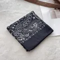 Detail of black paisley cotton bandana showing high-quality print and neat hemmed edges - Black Paisley