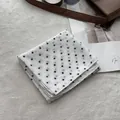 Detailed view of white polka dot cotton scarf with premium stitching on soft background - White