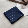 Detail of dark blue polka dot cotton scarf with fine stitched edges on white faux fur - Navy Blue