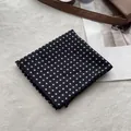 Detail of a black and white polka dot square scarf on white fur and bag strap - Fine Polka Dot Black