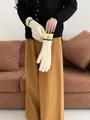 Detail of knitted touchscreen gloves showing ribbed texture and contrast wrist trim - Beige + Yellow