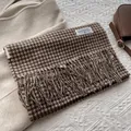 Close-up of retro houndstooth wool scarf with fringe edge and brand woven label - 180x30 / Coffee