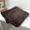 Close-up of a brown towel with leopard print trim made of absorbent terry cloth fabric - 90x180cm / Coffee