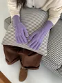 Detailed view of purple cable knit gloves with cozy ribbed cuffs and a small brand label - Taro Purple