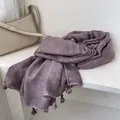 Detail view of purple plaid linen scarf featuring waffle texture and fringe with wooden beads - Purple