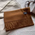 Detailed texture of dark brown 100% wool tassel scarf with premium fabric label - 180*30cm / Caramel Brown