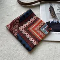 Detail of bohemian floral print cotton scarf on plush background with fashion props - Fret Pattern Red