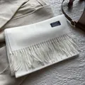 Detailed close-up of white 100% wool scarf featuring elegant tassels and a woven label - 180*30cm / White