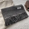 Detail of classic black and white houndstooth wool scarf with fringe and brand label - 180x30 / Black