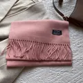 Detail of pink wool scarf with fringe and woven label for winter outfit styling - 180*30cm / Snow Bud