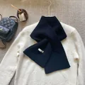 Detail of soft 100% Australian wool scarf in black, showing premium knit texture - Black