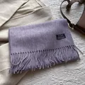 Close-up of lilac pure wool scarf with soft tassel detail and minimalist woven label - 180*30cm / Taro Purple