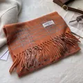 Detail of orange plaid wool scarf featuring long tassels and a branded fabric label - 180*30cm / Line Plaid Orange