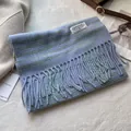 Detail view of high quality blue plaid wool scarf with elegant long fringes and brand label - 180*30cm / Line Plaid Blue
