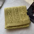 Detail of mustard yellow 100% wool scarf featuring chunky chain knit and ribbed hem edges - Yellow