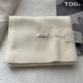 Ivory 100% wool scarf handmade winter wrap shown with fashion magazine on textured backdrop - Ivory