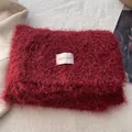 Detailed close-up of fluffy burgundy faux fur scarf featuring a BOWLOW brand label - Red