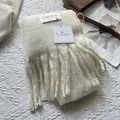 Detailed texture of off-white knitted scarf with tassels and elegant brand labeling - 180*30cm / Cream Rice