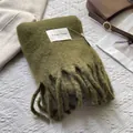 Close-up of olive green mohair scarf texture with chunky tassels and artisanal tag - 180*30cm / Army Green