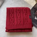 Detail of red 100% pure wool scarf showing thick knit texture and anchor chain pattern - Red