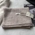 Detailed close-up of 100% pure wool scarf with edge stitching and premium texture - Off White