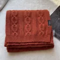 Close-up of orange 100% pure wool knitted scarf with embossed chain pattern texture - Pumpkin Orange