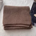 Nahaufnahme eines dunkelbraunen Schals aus 100% Wolle mit klassischer Rippstrickstruktur - Kaffeebraun