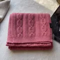 Detailed view of pink 100% wool knit scarf featuring premium chain-link textured pattern - Pink