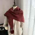Burgundy triangular knit scarf with faux fur pom-pom detail on winter coat - Ancorra Red