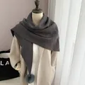 Dark grey knitted triangle scarf with pom-pom on a beige coat model - Dark Gray