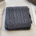 Detail of dark grey 100% wool scarf with cable knit texture and ribbed edge finish - Dark Gray
