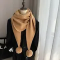 Detail of camel knit scarf featuring two fluffy faux rabbit fur pom-poms for winter - Large Triangle Pom-Pom Shawl Camel