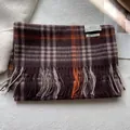 Detail shot of the 100% pure wool texture and fringe on the plaid British winter scarf - 180x30cm / Mocha Brown Plaid