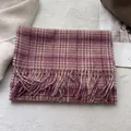 Detail of wool plaid scarf showing soft texture and fringe edges on a cozy background - 180x30cm / Girly Pink Plaid