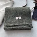 Detail of wool blend scarf featuring branded woven label and soft textured fabric - Army Green