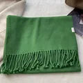 Detailed view of 100% pure wool green scarf with twill weave texture and fringe edges - Forest Green