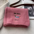 Detail of pink knitted scarf featuring a cute embroidered dachshund dog and heart pattern - Korean Pink