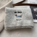 Detail of grey knitted scarf featuring embroidered dachshund and 'ONE BAGEL' text - Light Gray